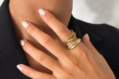 Close-up of a hand wearing gold plated brass ring.